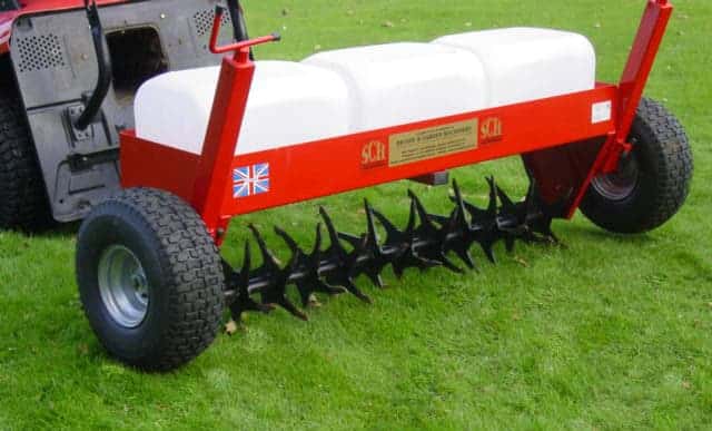Carrier frame with lawn aerator attachment