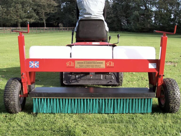 Brush attachment for applying top dressing and sand to lawns